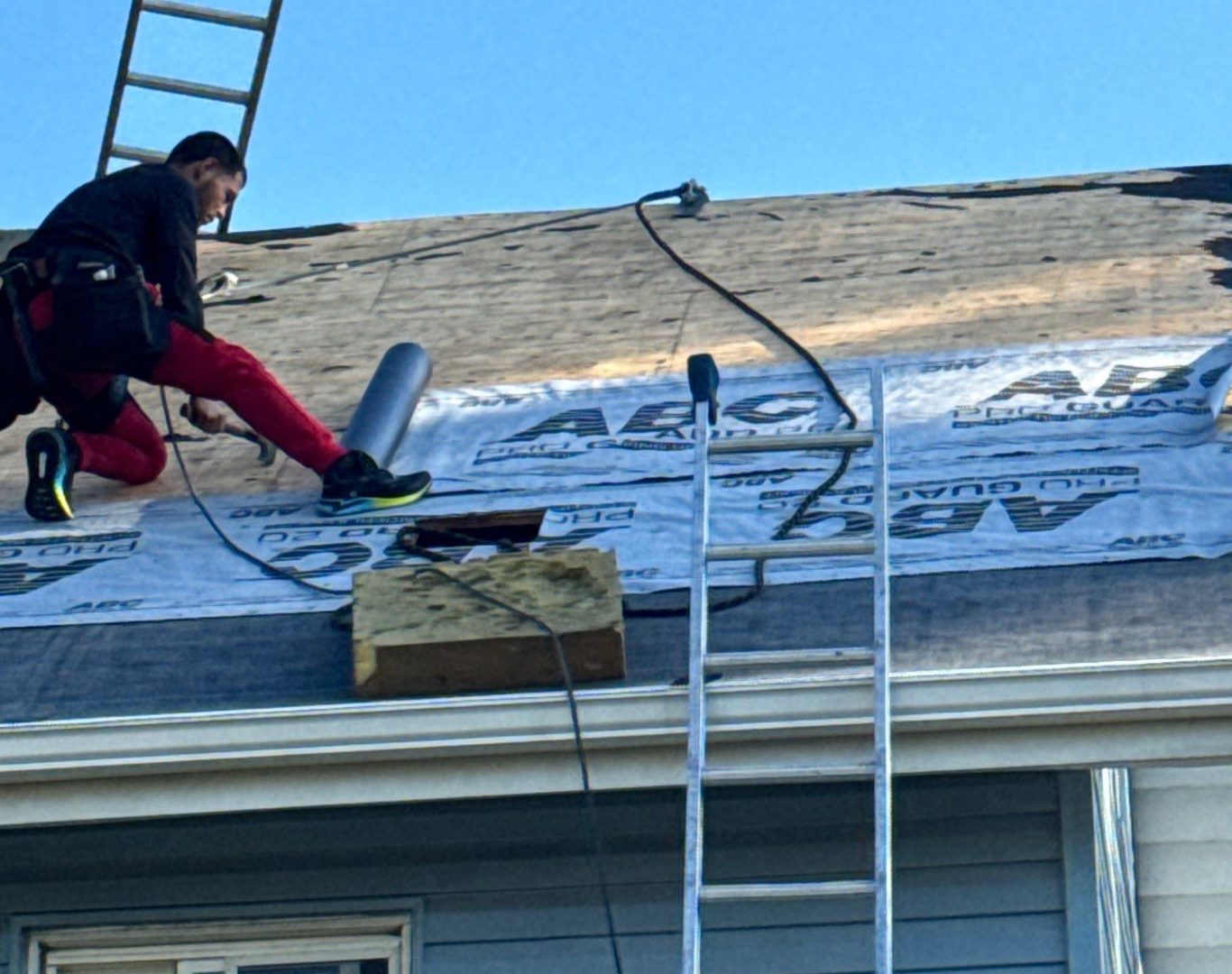 Roof repair specialist evaluating storm-damaged Cupertino, CA roof with moisture-detecting tools