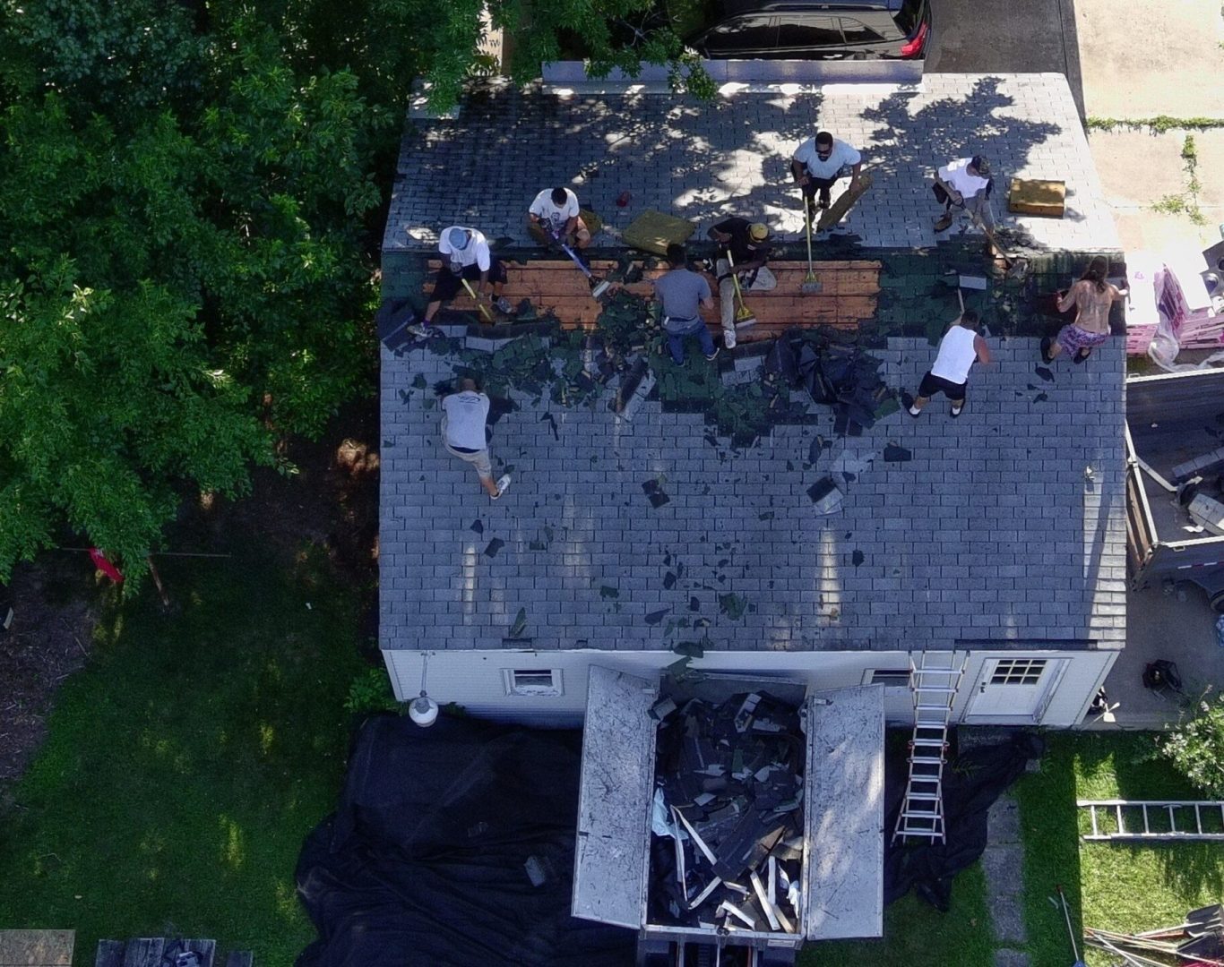Roofing team repairing a storm-damaged shingle roof on a Redwood City, CA family home