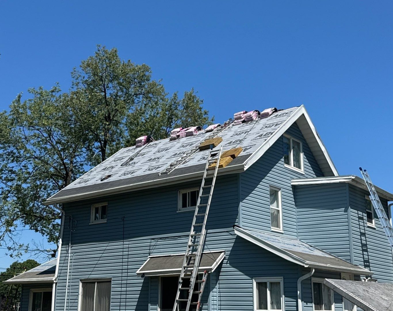 Licensed roofer performing inspection with digital tools on modern Menlo Park office building rooftop