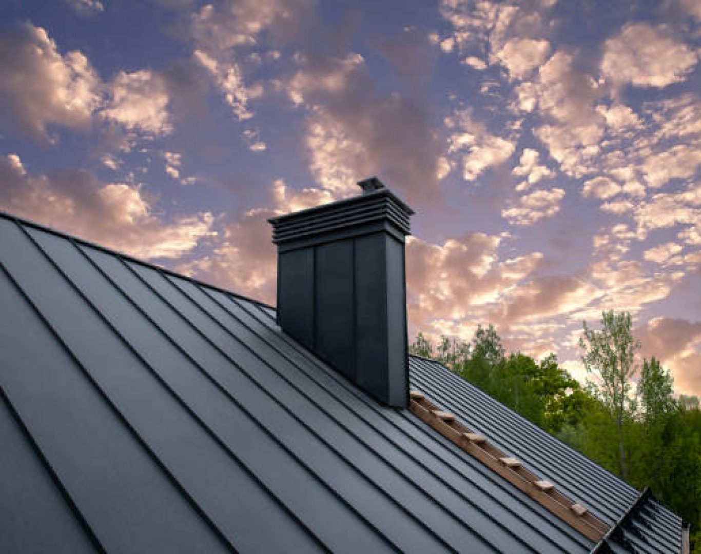 Roofing specialists measuring metal roofing sections on a Redwood City, CA home before panel placement
