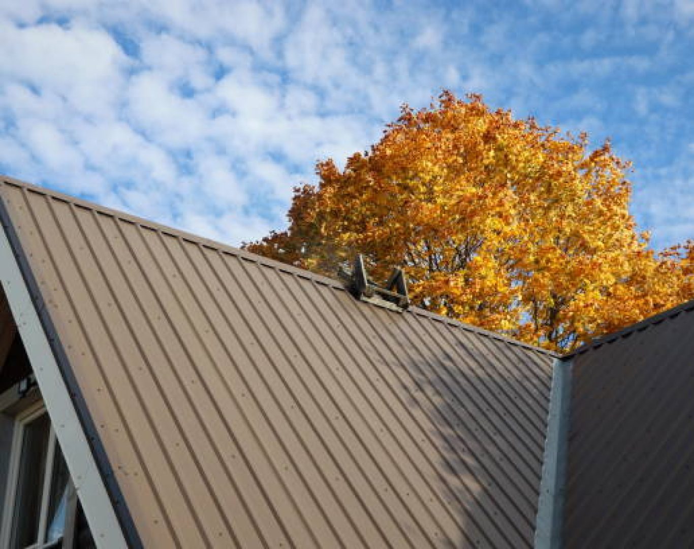 Metal Roofing in San Jose, CA being installed as a crew aligns standing seam panels on a home