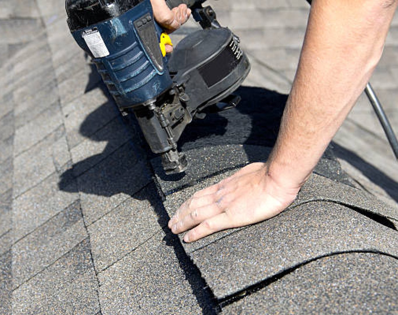 Roof repair specialist inspecting cracked flashing on a Pleasanton, CA home after seasonal rain